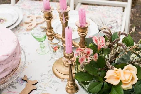 Pink candles in a candlestick on a table Stock Photos