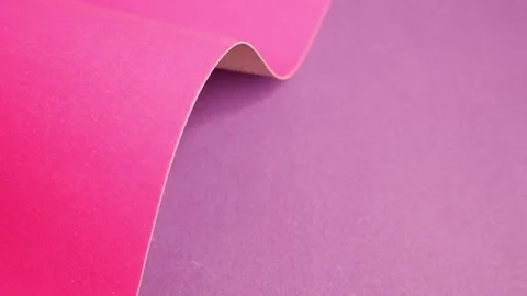 Pink cardboard on a purple background. The texture of the cardboard. Stock Footage 157393218