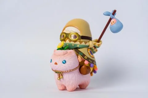 Pink cat rides small creature with golden hat and goggles Stock Photos