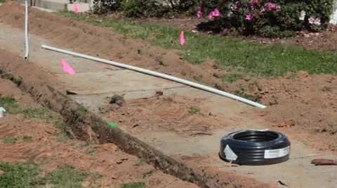 Pink Caution Flags Warn of Plumbing Trench Dug Along Sidewalk Stock Footage 46890496