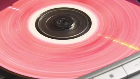 Pink CD spins inside vintage player, radiating playful 90s vibes with soft light Video stock 305573546