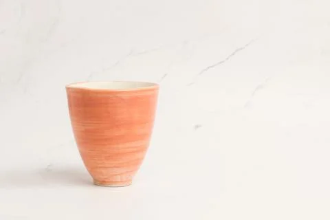 A pink ceramic cup on a marble background Stock Photos