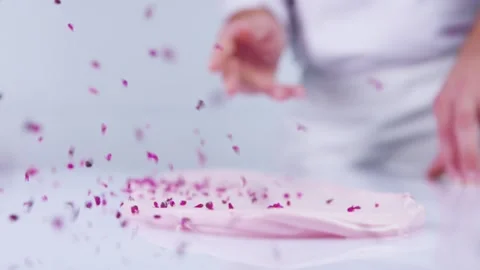 Pink chips are falling on cream cheese. Stock Footage 130852336