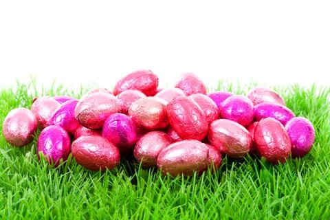 Pink chocolate easter eggs on grass Stock Photos