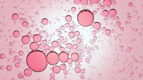 Pink clear bubbles move spontaneously in transparent liquid Stock Footage