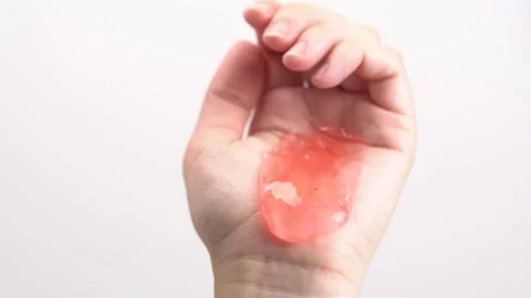 Pink clear shower gel with bubbles flowing from palm of hand. Stock Footage 277631206
