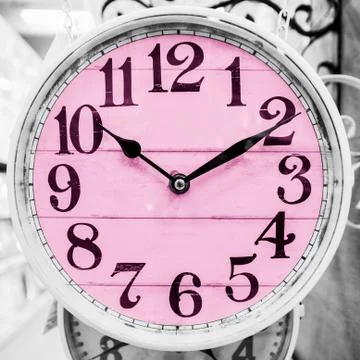 Pink clock in a classical style. Stock Photos