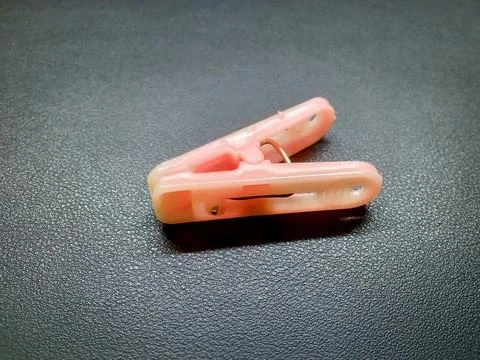 Pink clothespin on a black background Stock Photos