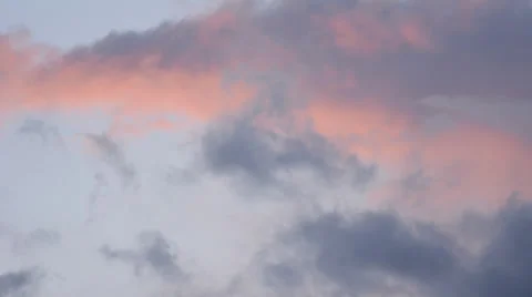 Pink cloud among darker clouds time lapse up high and close 4K version Stock Footage 24773547