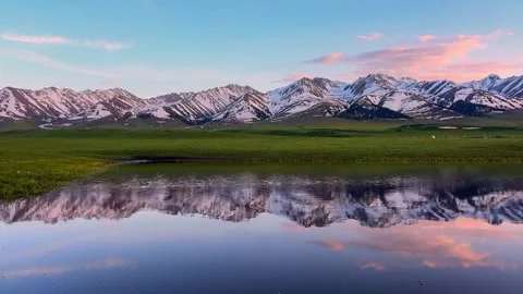 Pink Clouds and Snow Mountain Reflection on Alpine Lake at Twilight Stock Footage 333726256
