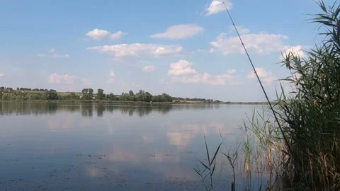 Pink clouds are reflected in the lake. Stock Footage 141134635