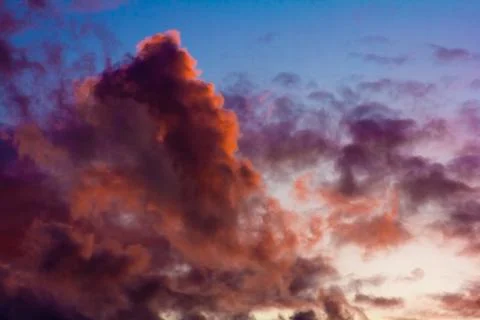 Pink clouds on a background of blue sky at sunset Stock Photos