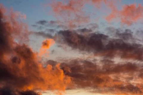 Pink clouds on a background of blue sky at sunset Stock Photos
