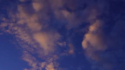 Pink clouds on a blue sky background Stock Photos