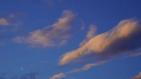 Pink clouds on a blue sky background Stock-Fotos