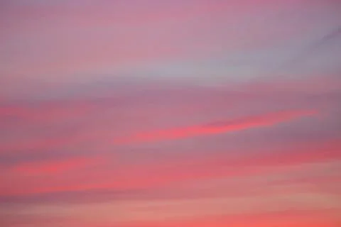 Pink clouds in blue sky Stock Photos