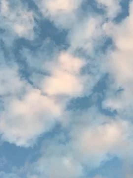 Pink clouds in the blue sky. Summer, sunset sky Stock Photos