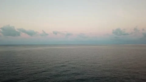 Pink clouds at dawn. Flying over the sea. Video stock 132732046