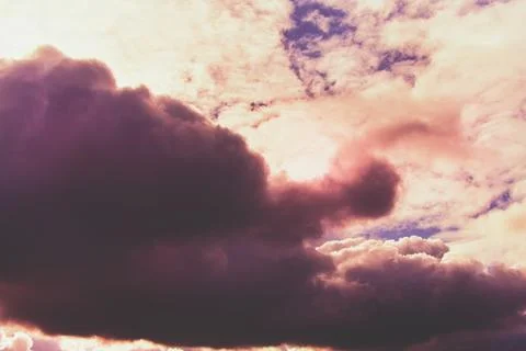 Pink clouds in the evening sky, evening pink light on the clouds Stock Photos