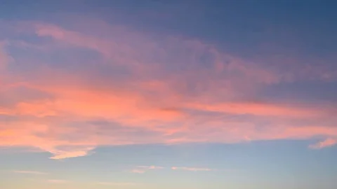 Pink clouds move rapidly across the blue sky. Stock Footage 107586787