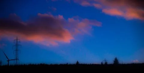 Pink clouds over landscape Stock Photos