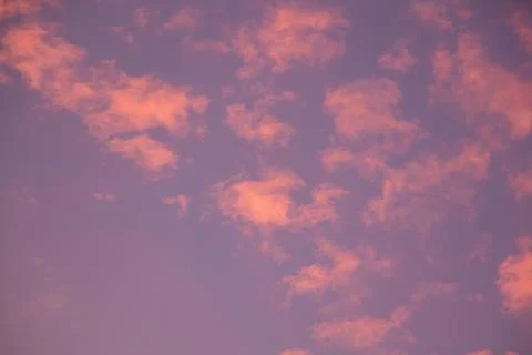 Pink clouds in the sky at sunset Stock Photos