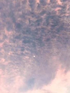 Pink Clouds with Sun Glimpse 스톡 사진