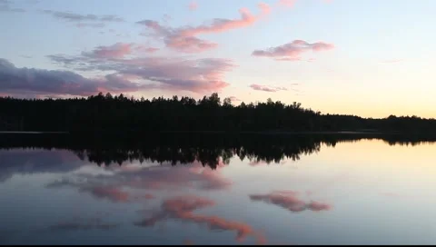 Pink clouds on sunset on forest lake Stock Footage 1217631