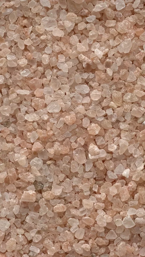 Pink coarse grain salt. Table spin. Vertical video. Video stock 279578871