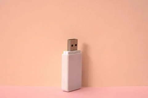 Pink color background and white USB memory storage. Stock Photos