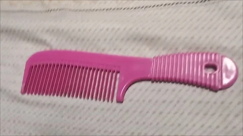 The pink comb is very comfortable to use Stock Footage 293056846