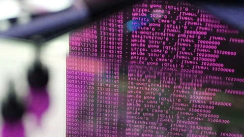 Pink computer software code moving on a black monitor reflect on glass. Abstr 스톡 동영상 144047822