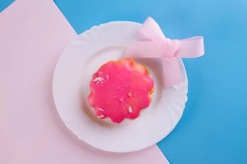 Pink cookie on blue background Stock Photos