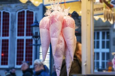 Pink cotton candy in transparent triangular bags at a holiday fair outside Stock Photos