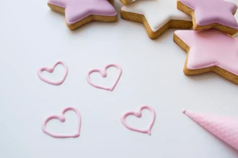 Pink cream hearts and gingerbread stars in pastel shades Stock Photos