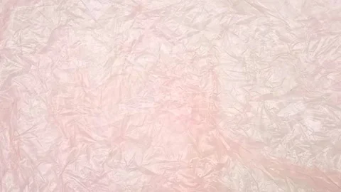 Pink crumpled plastic bag texture background rotating. Low-Density Polyethylene Stock Footage 316381308