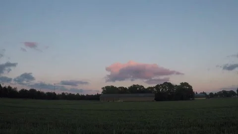 Pink cumulus cloud moving away Stock Footage 196832443