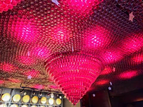 Pink decorative ceiling installation with glowing lights 스톡 사진