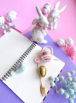 Pink Desktop. Notebook on the table with easter decorations. Stock Photos