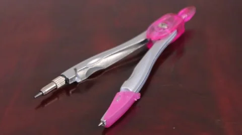 Pink dividers (compass) on the table Stock Footage 53281399