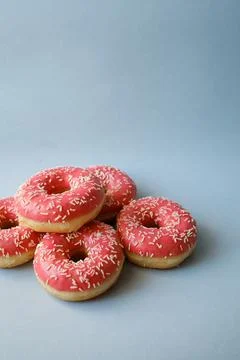 Pink donuts on blue background with copy space Stock Photos