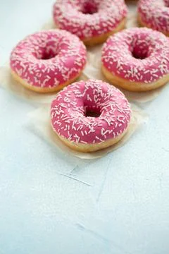 Pink doughnuts in icing sugar. Stock Photos