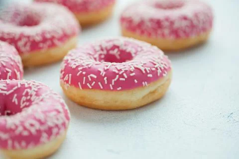 Pink doughnuts in icing sugar. Stock Photos