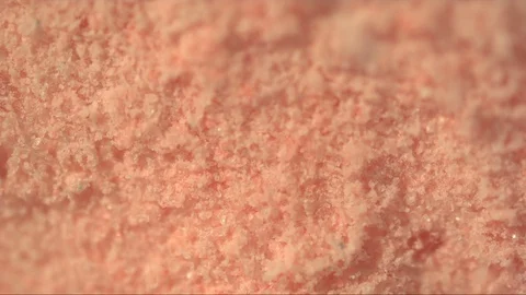 Pink dust particles flying around in macro slow motion Stock Footage