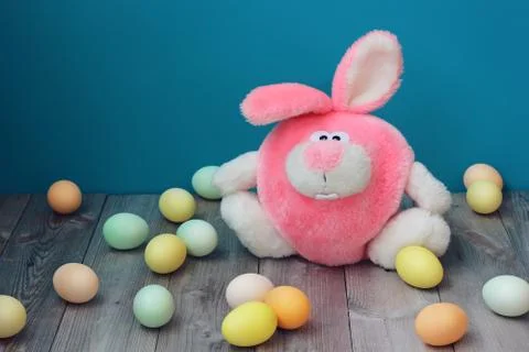 Pink Easter Bunny and colored eggs at Easter. Stock Photos