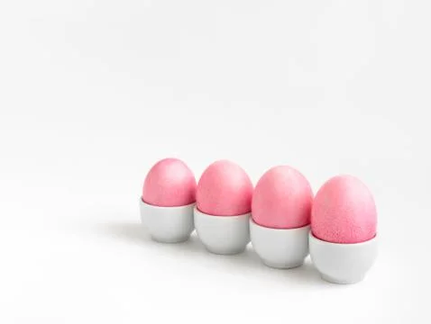 Pink Easter chicken eggs on a white background. Minimalism.  Stock Photos