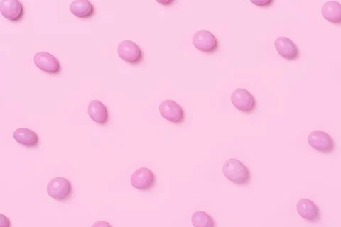 Pink easter dragee on a pink background Stock Photos