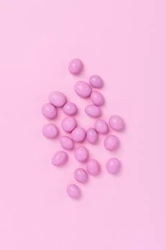Pink easter dragee on a pink background Stock Photos