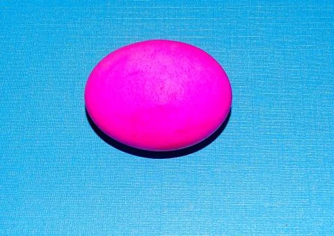 Pink Easter egg with a blue background. Stock Photos