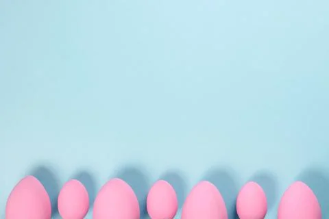 Pink Easter eggs on a blue background Stock Photos